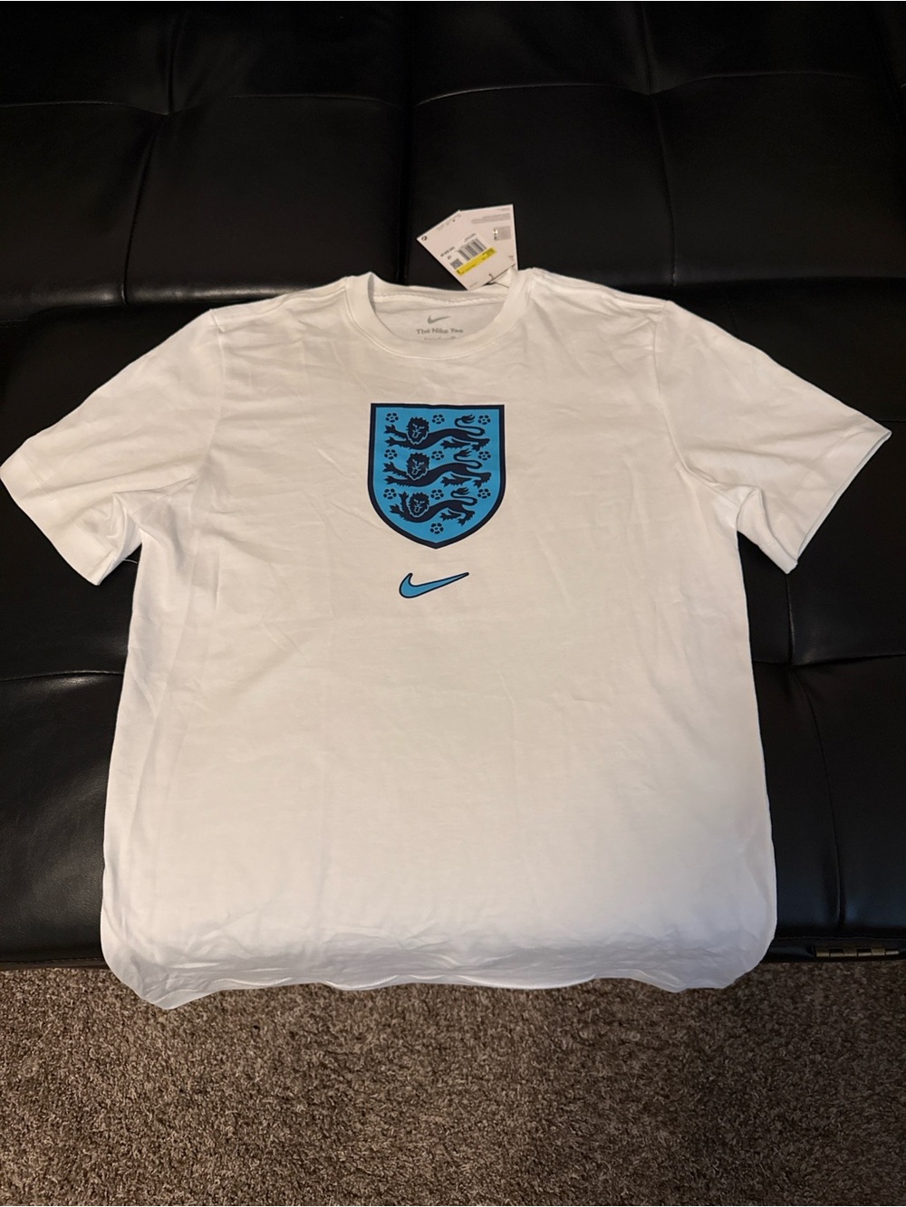 Nike Men’s White Tee with Light Blue Crest and Swoosh